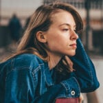 Woman looking thoughtfully into distance as symbol for flaky person